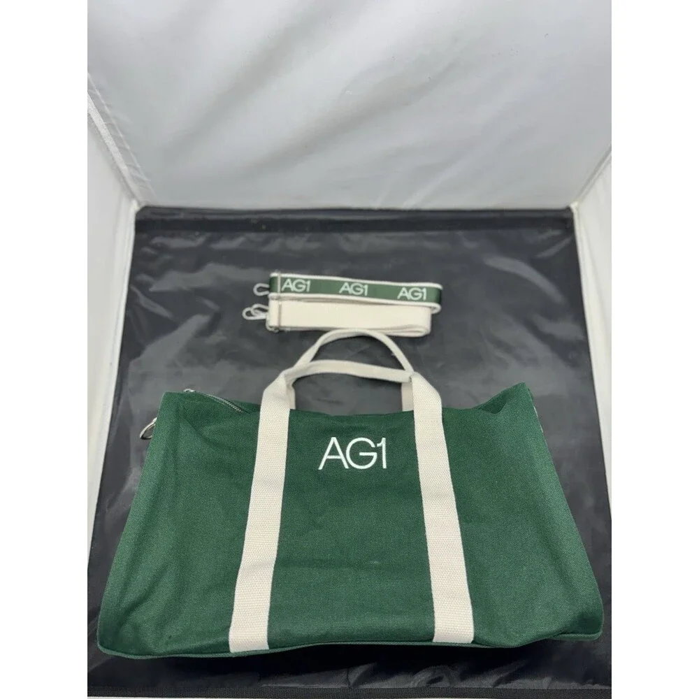 AG1 Duffle Bag Unisex Green Canvas White Handles Accents Adjustable Strap NWOT